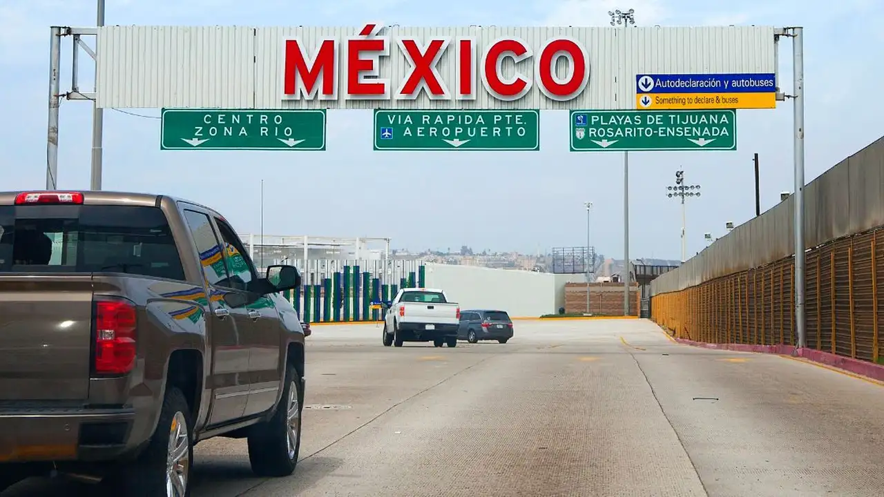 Close up on a plate of mashed potatoes, topped with baked pork chops with cream of mushroom soup, and a side of green beans.
